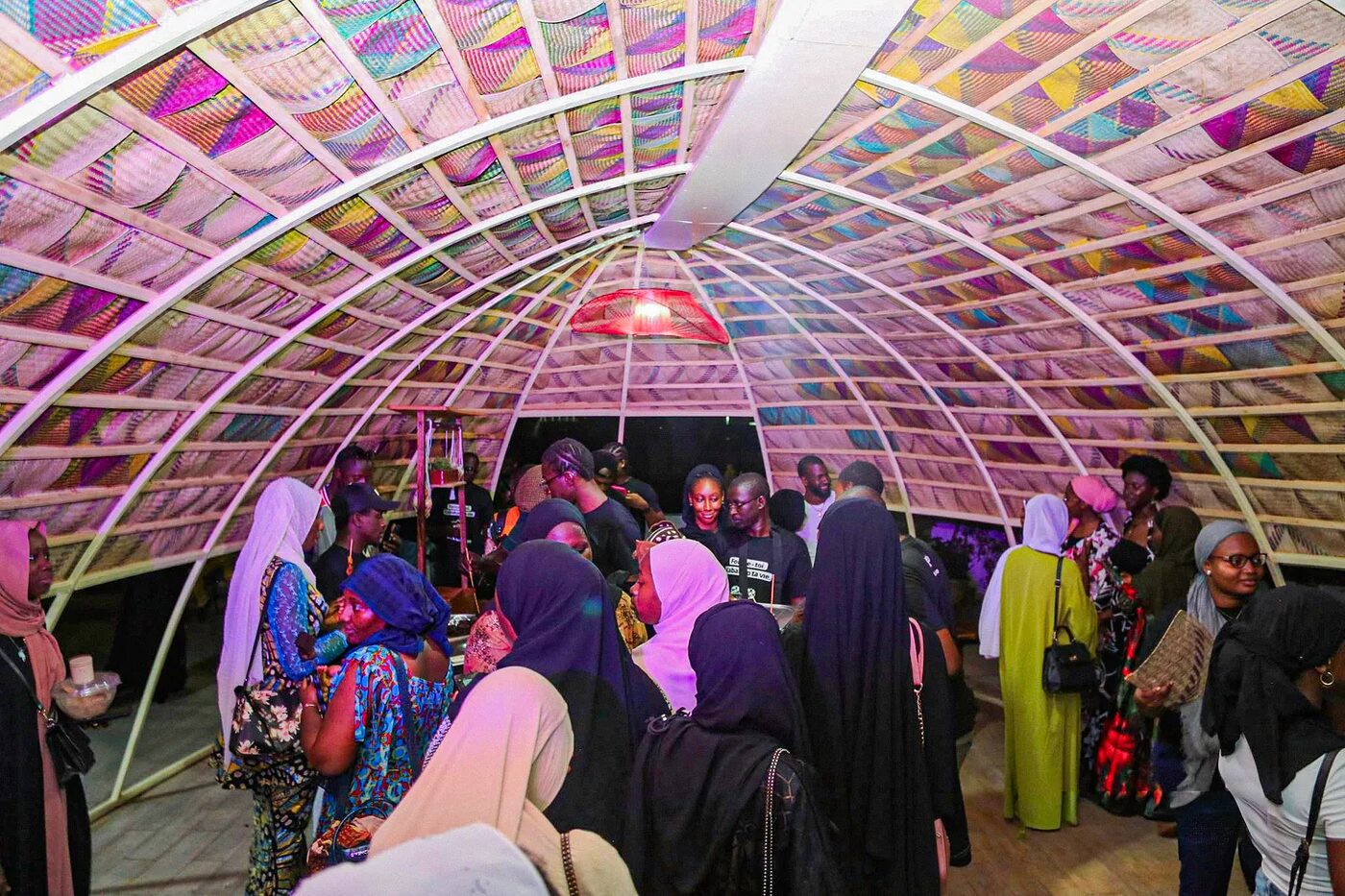 Inside Le Nid de Bamako on opening night: a crowd gathered under a glowing dome woven from two thousand hand fans.