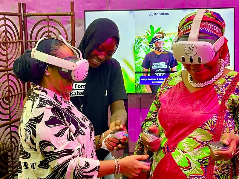 A Kabakoo learner guides two visitors wearing VR headsets at Kabakoo's stand during Mali's National Digital Week.